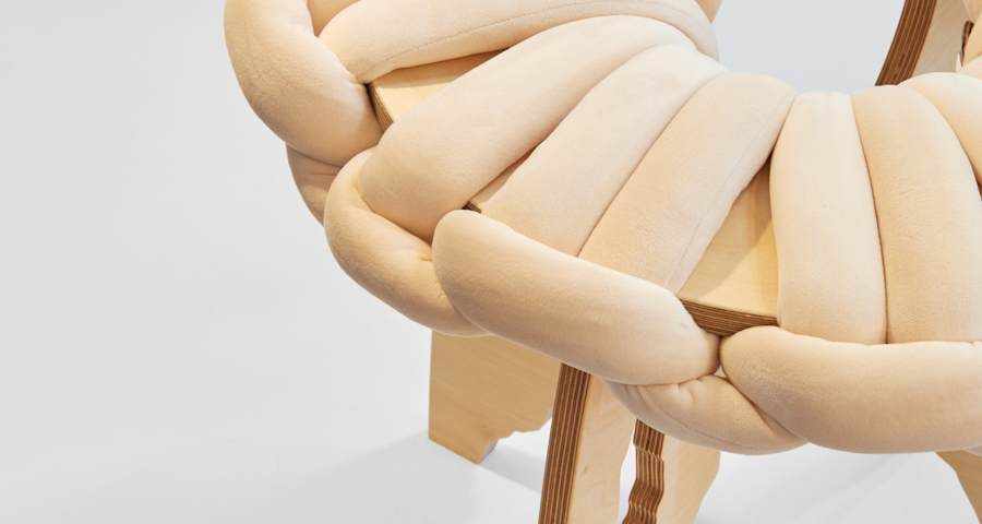 A cream coloured piece of furniture against a white backdrop